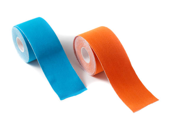 Kinesiology tape for taping in blue and orange on a white background, isolate. Close-up, treatment