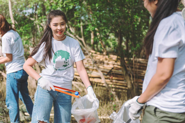 istock Group of asian diverse people volunteer teamwork ,environment conservation,volunteer help to picking plastic and foam garbage on park area.Volunteering world environment day. 1393976433