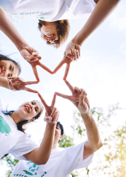 istock Close up of people volunteer teamwork putting finger on star shape,hands together,Stack of hands,Unity and teamwork on world environment day. 1393976592