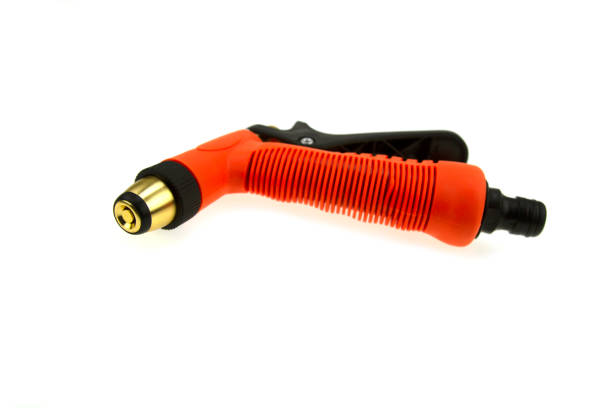 istock Hose nozzle spraying water isolated on white background. 1393977753