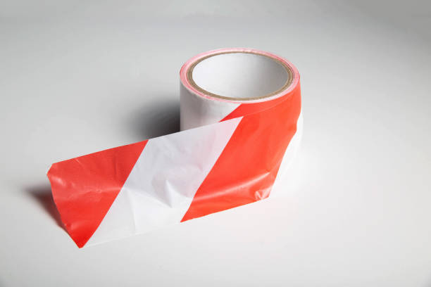 istock Red-white striped ribbon on a white background, isolate. Prohibition tape, close-up 1393978286