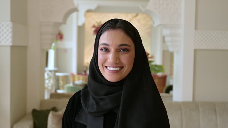 Indoor portrait of cheerful young Middle Eastern woman