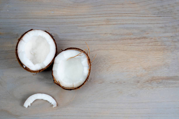 istock Coconut splits on wooden background 1393982296
