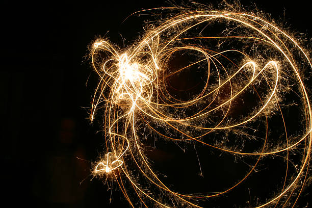 Orange sparkler circles on a black background