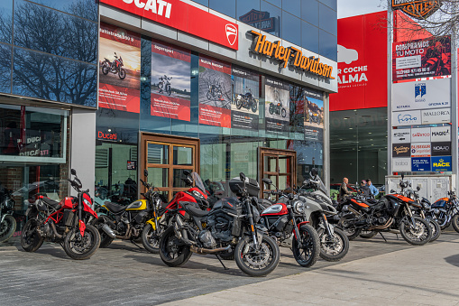 Palma de Mallorca, Spain; april 08 2022: Dealership selling Harley-Davidson and Ducati motorcycles, with motorcycles on display on the outside. Palma de Mallorca, Spain