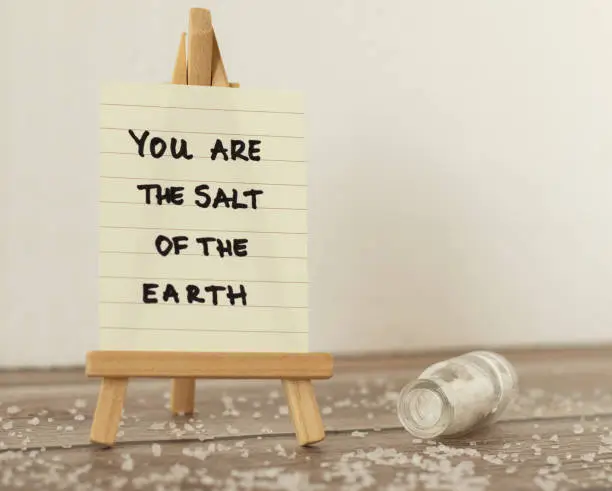 Salt of the earth handwritten quote from Holy Bible Book. Teaching sermon of God Jesus Christ. The biblical concept of faithful Christian believers. Disciple's obedience and purity. The gospel message.