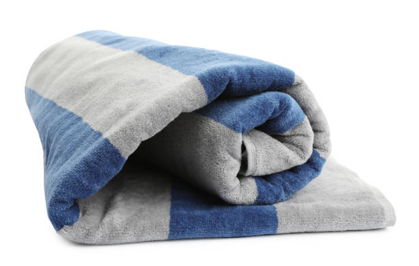 istock Rolled striped beach towel isolated on white 1393990522