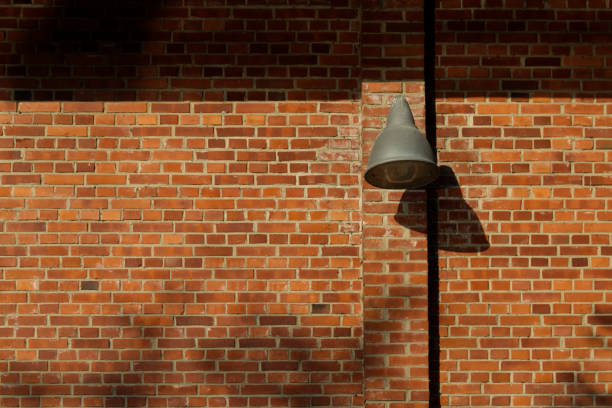 istock Old lamp on a brick wall with plenty copy space 1393990589