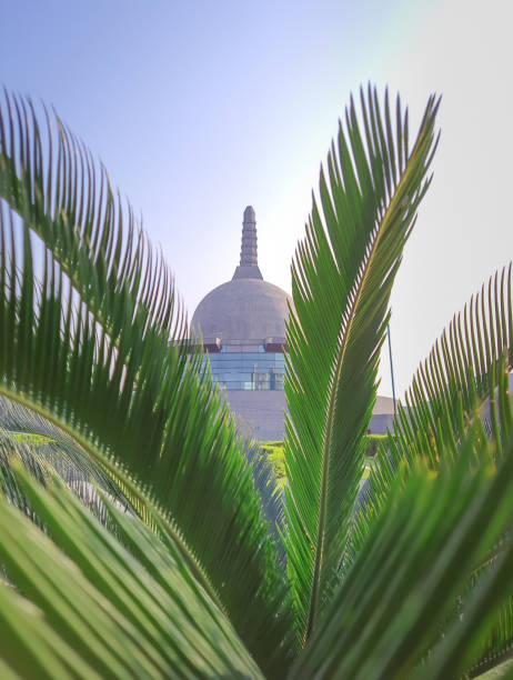 istock buddha stupa through leafs with bright sky at morning from low angle 1393990894
