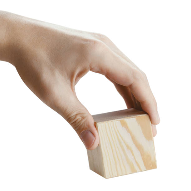 istock Hand holding a wooden cube on white 1393991904