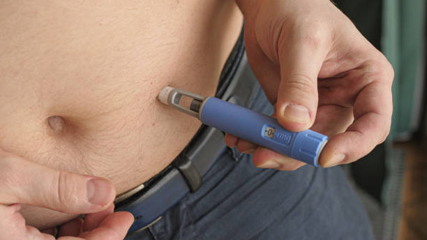 obese fat man injecting Semaglutide Ozempic injection control blood sugar levels obese fat man injecting Semaglutide Ozempic injection control blood sugar levels wegovy stock pictures, royalty-free photos & images