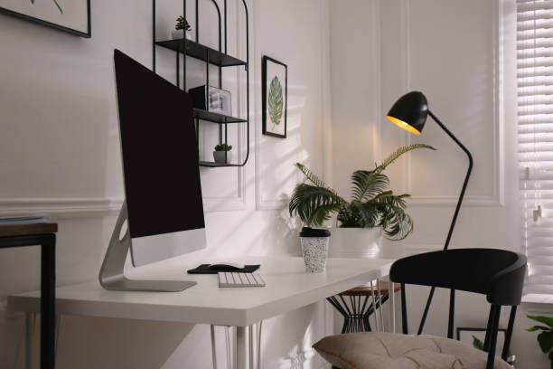 istock Comfortable workplace with modern computer and houseplants in room. Interior design 1393991988