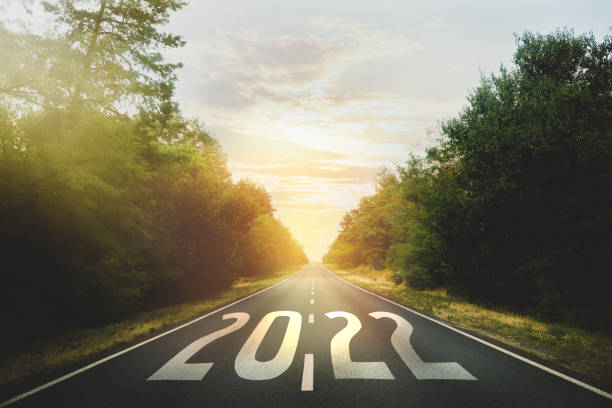 istock Start new year with fresh vision and ideas. 2022 numbers on asphalt road 1393992057