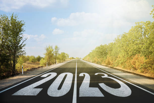 istock Start new year with fresh vision and ideas. 2023 numbers on asphalt road 1393992319