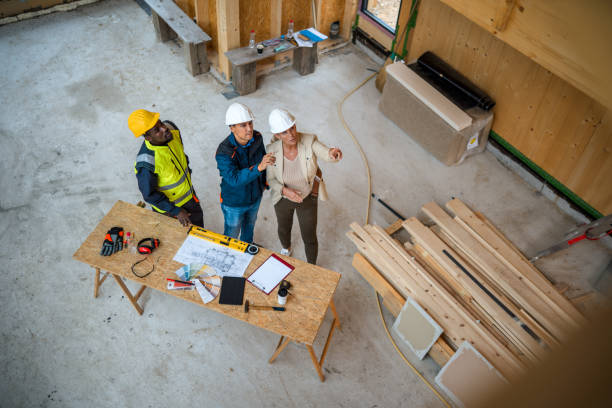 istock Mature Female Boss Giving Instructions To Construction Workers 1393993418