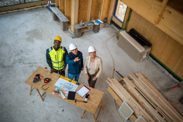 istock Homeowner And Construction Workers Discuss About The Insulation Of The Roof 1393993421