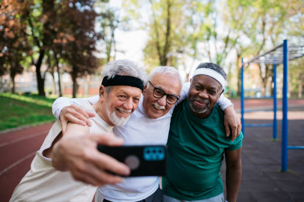 istock Three happy senior men taking a selfie with a smart phone 1393995187