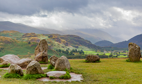 Castlerigg Stone Circle in the English Lake District, Cumbria, England with hills and a valley in the background