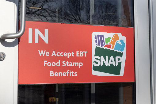 Chicago - Circa April 2022: SNAP and EBT Accepted here sign. SNAP and Food Stamps provide nutrition benefits to supplement the budgets of disadvantaged families.