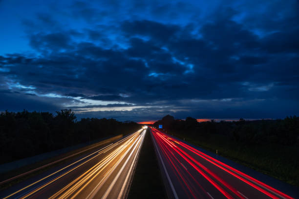 istock Night traffic scene with light trails on highway long exposure 1393997471