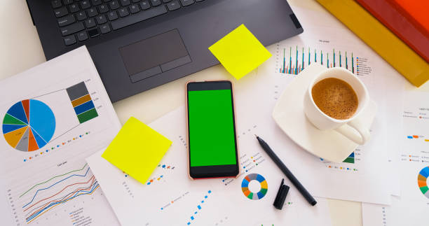 istock Business office desk with green screen smartphone 1393997640