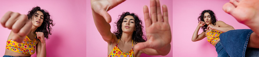 A horizontal composite image of portraits of a young woman putting her hands up, punching and kicking towards the camera while looking at smiling slightly. She is in front of a pink background.