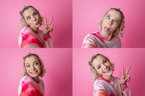 A composite image of portraits of a young woman making faces and smiling at the camera while making the peace gesture. She is posing in front of a pink background.