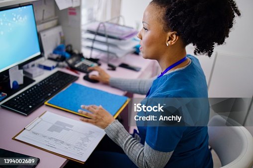istock Nurse working at the reception desk in the private clinic 1394002689