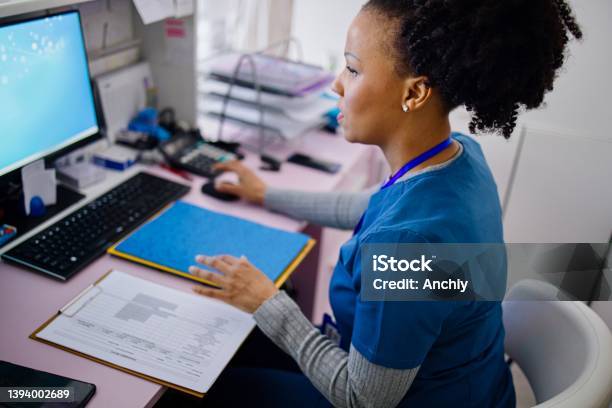 Nurse Working At The Reception Desk In The Private Clinic Stock Photo - Download Image Now