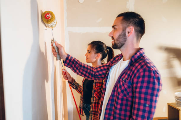istock Young couple painting wall 1394002855