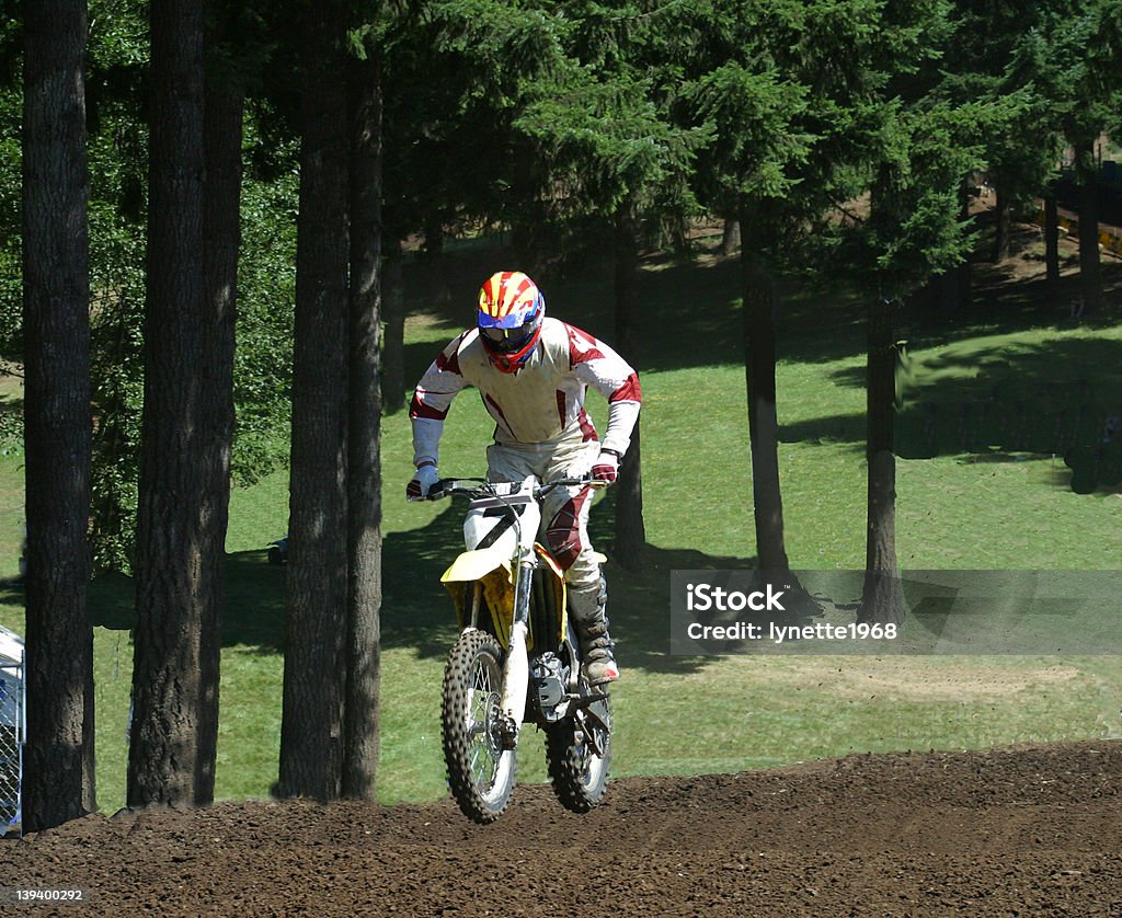 Motocross Race in the Trees Motocross racer riding through a series of whoops. 6-7 Years Stock Photo