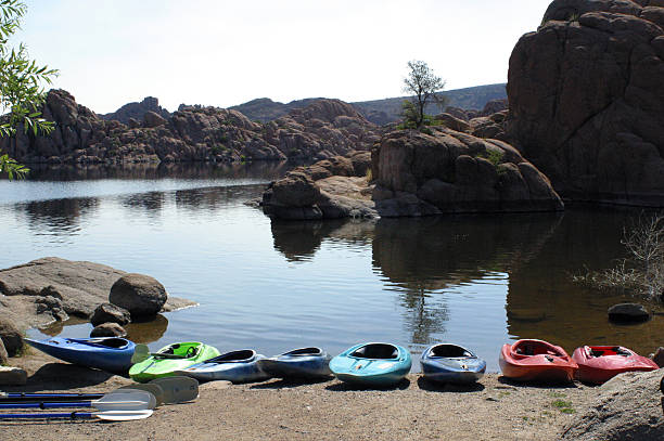 8 kayaks sitting on the shor of Watson Lake in Prescott, Arizona.