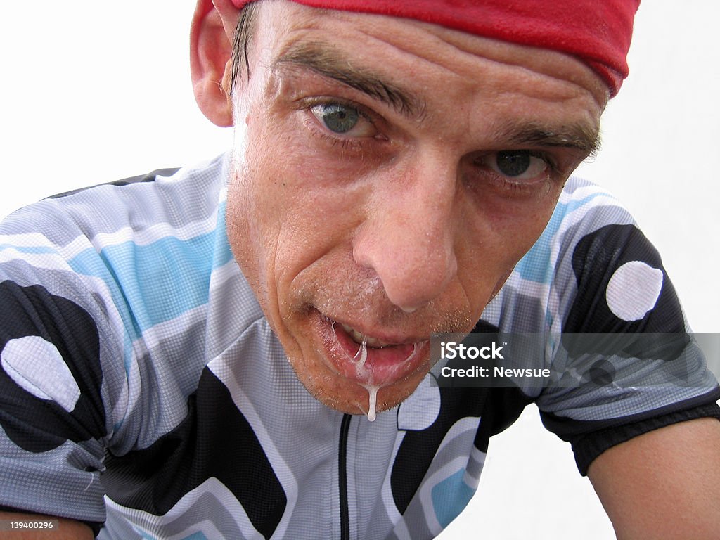 Exhausted bike rider A very tired bike rider all sweaty and slimy looking after an uphill climb. Notice his adrenaline filled eyes. Cycling Stock Photo