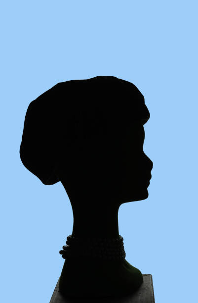 istock puppet head silhouette profile wearing 20s hat, blue background 1394004410