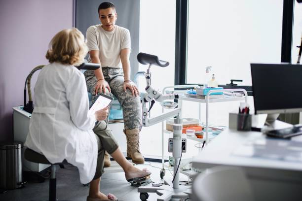 Gynecologist doctor going over test results with soldier patient A female soldier is being examined by a gynecologist reproductive rights stock pictures, royalty-free photos & images