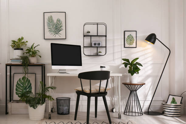 istock Comfortable workplace with modern computer and houseplants in room. Interior design 1394005094