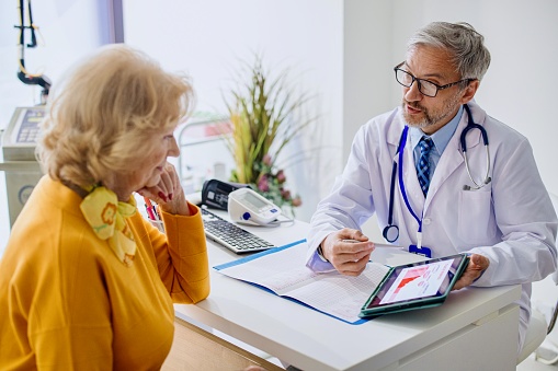 Senior woman with male gynecologist during the consultation in the gynecological office