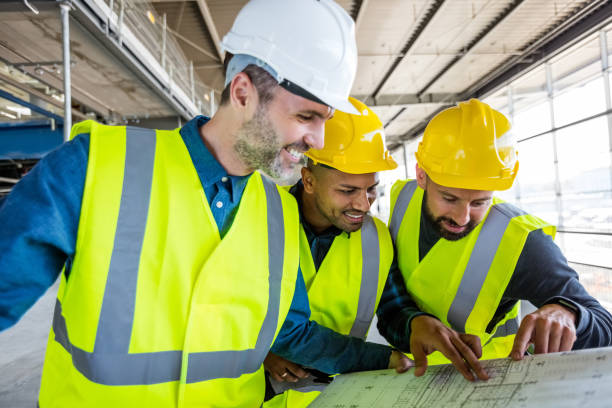 istock Architect and builders at an indoor construction site 1394005477
