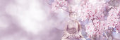 istock flowering cherry tree around buddha statue on sunny blurred spring background, idyllic nature scene in sunhine, web banner concept with copy space 1394008233