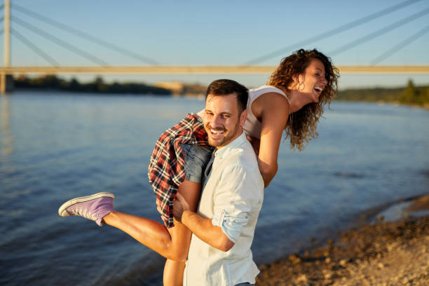 istock Couple in love having fun together by the river 1394008866