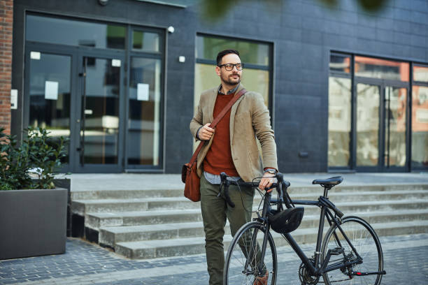 istock Businessman commuting to work with his bicycle 1394009096