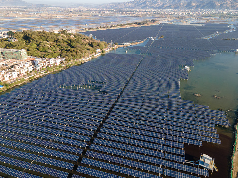 Neat rows of solar panels by the sea