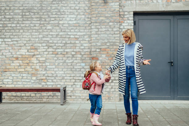 istock Mother taking her daughter to school 1394010992