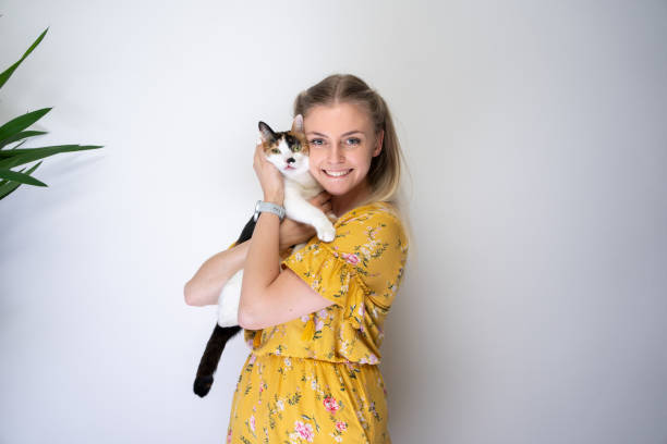 istock young blond woman embracing her cat with copy space 1394012225