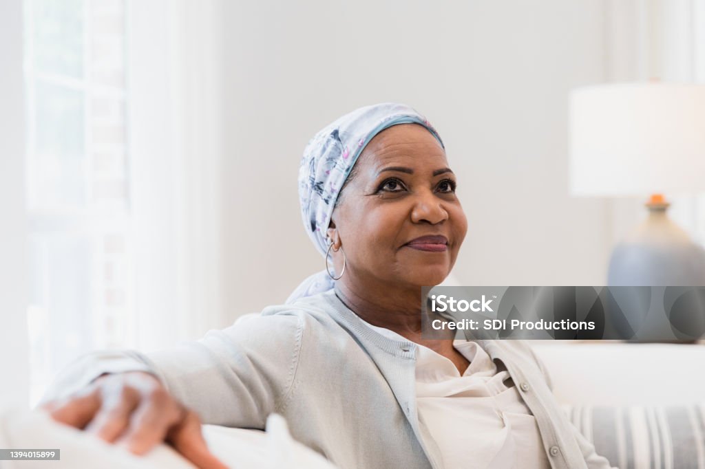 Cancer patient contemplates upcoming decisions The elderly woman with cancer looks off into the distance and sits alone to contemplate upcoming decisions. Cancer - Illness Stock Photo