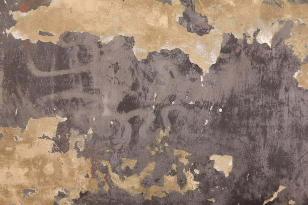 istock A weathered and damaged old wall, grunge texture background. Concrete surface with peeling paint. 1394016339