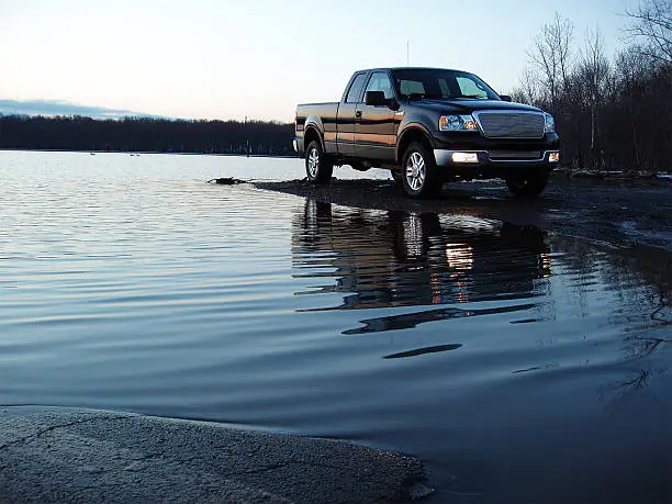 A great shot featuring a new body style 2004 Ford F-150 Lariat 4X4 Supercab parked near water.