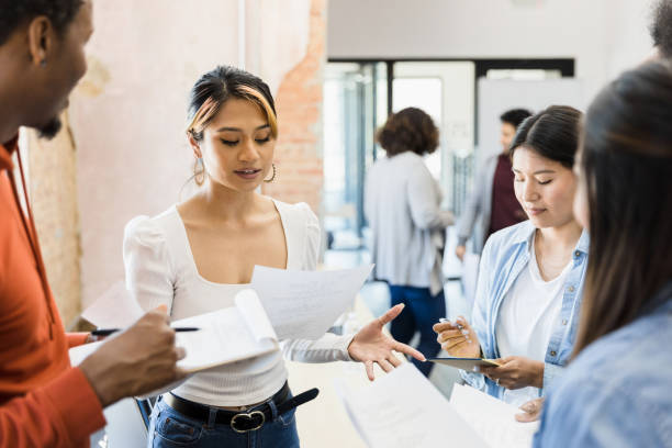 Directors take notes as actress reads part Standing in a group together, the directors take notes as the young adult actress reads her part. theater industry stock pictures, royalty-free photos & images