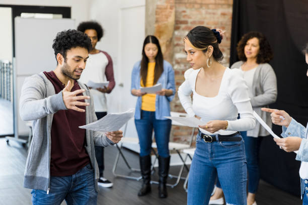 Diverse actors practice play in studio The multiracial group of actors practice the play in the studio.  They each read from a script. theater industry stock pictures, royalty-free photos & images