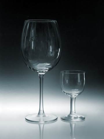 Empty cocktail glassware on a black background.